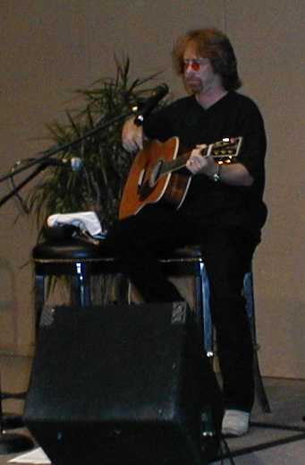 Bill Mumy tuning up for his concert at Dragon*Con 2000.